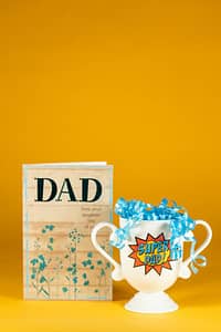 Card for dad and a mug that says "Super Dad!" in front of a yellow background