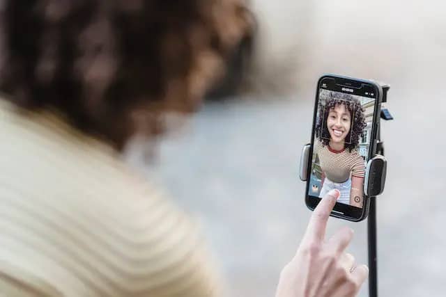 Woman filming herself with her selfie cam