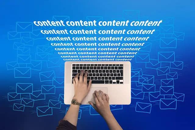 Laptop keyboard with the word "content" coming out of it multiple times.